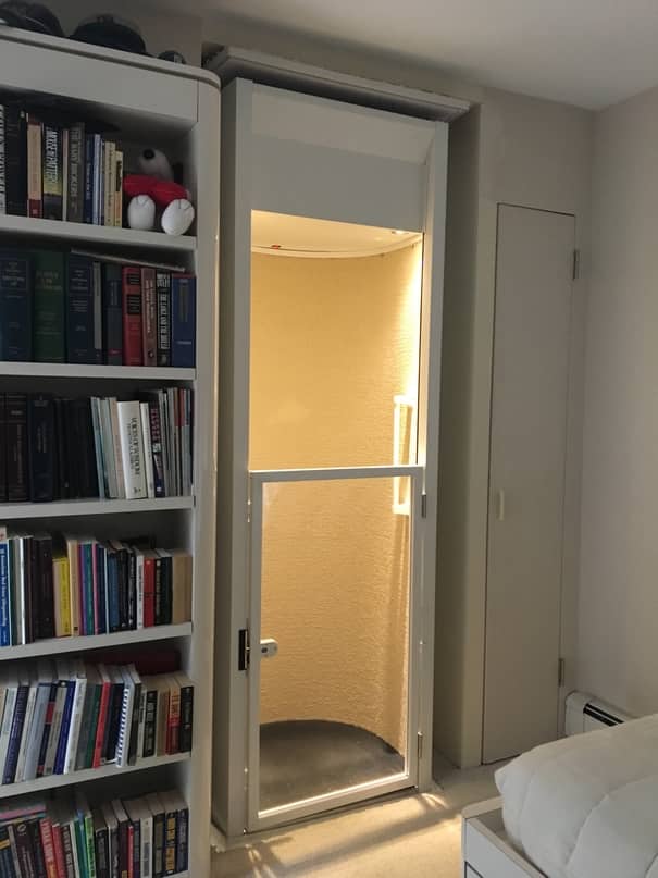 stiltz elevator installed in home next to bookshelf